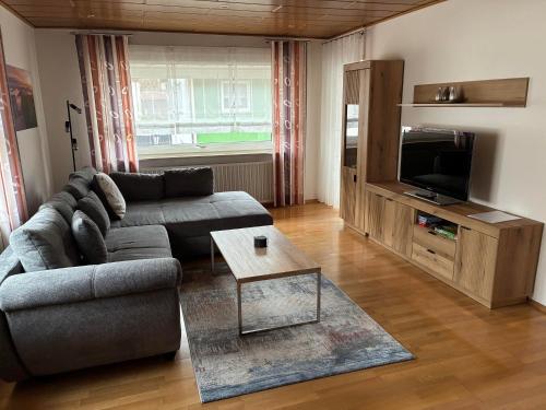 a living room with a couch and a tv at Ferienwohnung Felsenidyll in Bundenthal