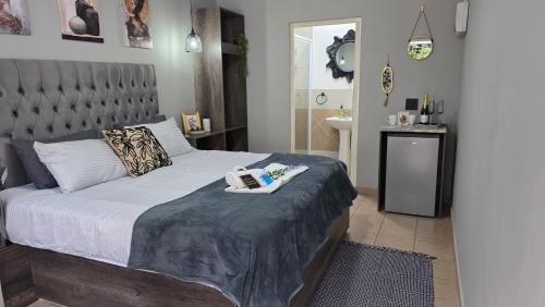 a bedroom with a bed with a towel on it at Phola Lodge OR Tambo in Kempton Park