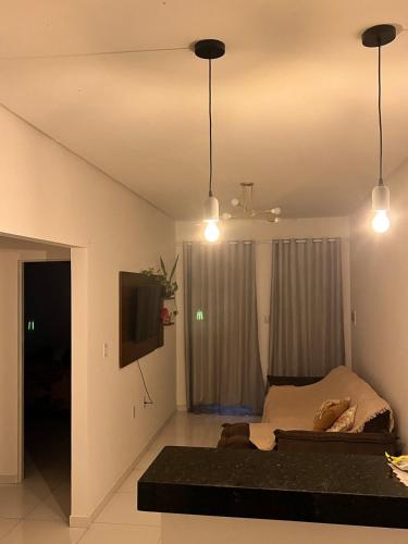 a bedroom with a bed and a tv and lights at Aconchego e conforto in Bom Jesus da Lapa