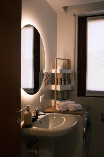 a bathroom with a sink and a mirror at Casa Delfina - Bergamo in Torre Boldone