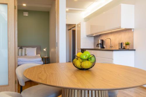a kitchen and a table with a bowl of fruit on it at TEN Apartments - Kuressaare in Kuressaare