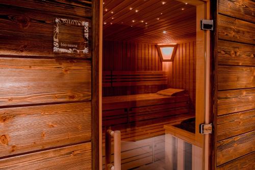 a sauna in a wooden cabin with a window at Hotel Piz Buin Klosters in Klosters