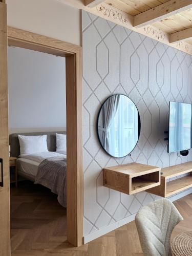 a bedroom with a mirror and a bed at Białe Wierchy Kościelisko in Witów