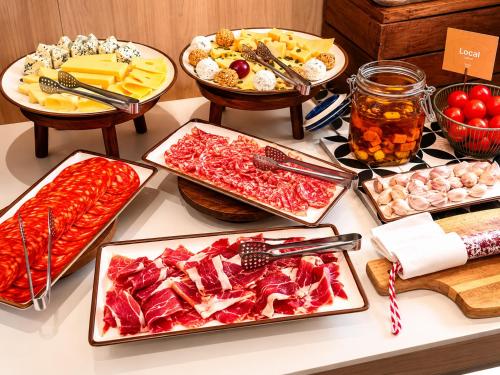 a buffet with different types of food on a table at Petit Palace Museum in Barcelona