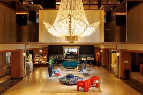 a large lobby with a large chandelier in a building at Kokusai 21 International Hotel in Nagano
