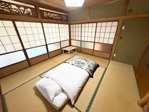 a room with a bed in a room with windows at 別邸 先山 in Kamikatetsu
