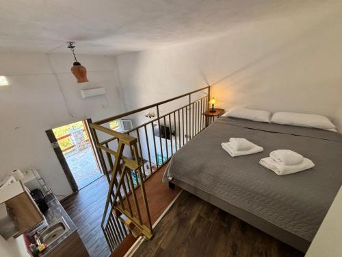 a bedroom with a bed with two white towels on it at Βαχος rooms 3 in Areopoli