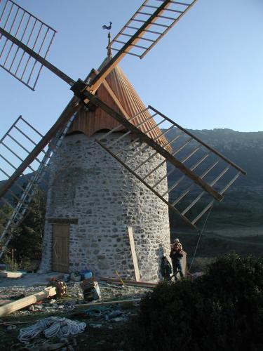 a windmill on top of a hill with people standing next to it at Apartment the Haven in Cucugnan