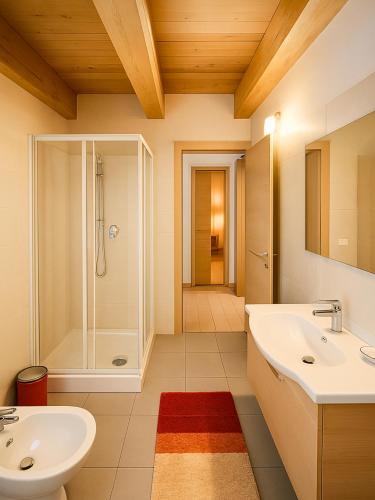 a bathroom with two sinks and a shower at ValtellinaHome in Villa di Tirano