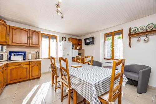 a kitchen with a table and chairs in a kitchen at L'instant ROSE - Escapade Champêtre in Grazac
