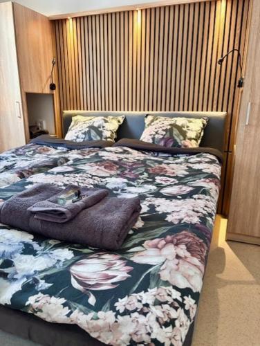 a bedroom with a bed with flowers on it at Frost Longstay City in Kiruna