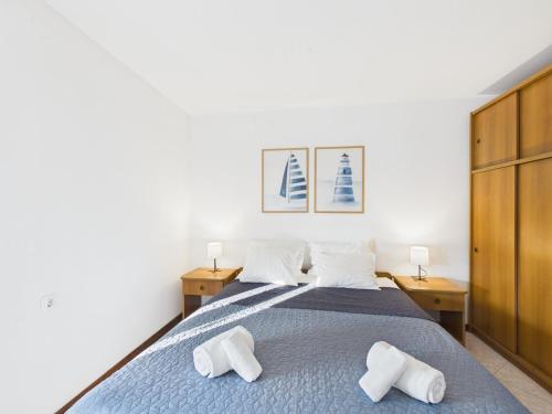a bedroom with a bed with two white towels on it at Apartments Jan in Banjole