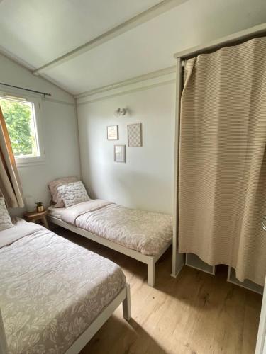 a bedroom with two beds and a window at Chalet paisible in Rivières
