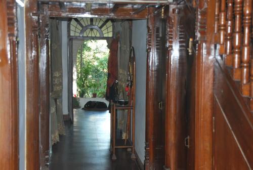 a hallway of a room with wooden walls at Hilltop Lodge in Guwahati