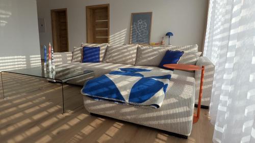 a living room with a couch and a glass table at Apartment Nordic in Veselé