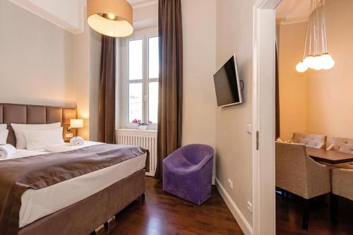 a bedroom with a bed and a desk and a window at Arabel Design Apartments in Berlin