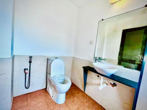 a bathroom with a toilet and a sink at Beachside Studio Apartment Baga in Baga