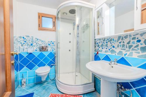 a blue bathroom with a shower and a sink at Rai's Private Apt 3 - Panorama & Relax in Stazione Olbia