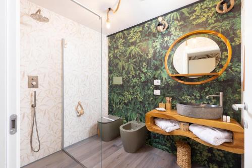 a bathroom with a sink and a mirror at Eteria Luxury Rooms Spa & Wellness in Posada