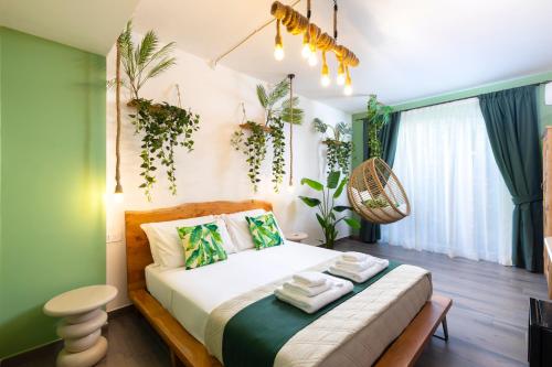 a bedroom with a bed with plants on the wall at Eteria Luxury Rooms Spa & Wellness in Posada
