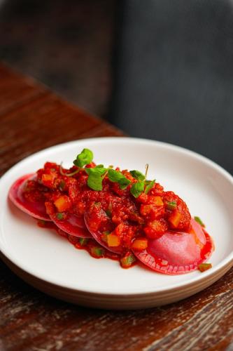 a plate of food on a wooden table at Riva Boutique Hotel in Helensburgh
