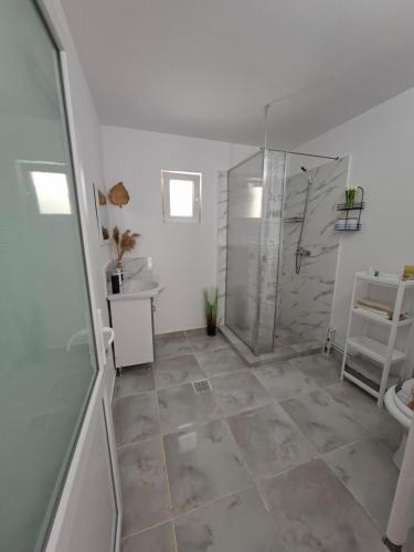 a bathroom with a shower and a toilet and a sink at Casuța Râului in Zărneşti