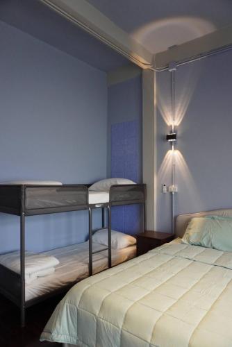 a bedroom with two bunk beds and a blue wall at Room with a Temple View in Bangkok