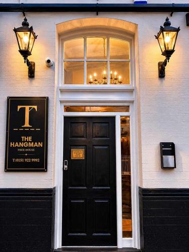 a building with a black door and a window at GuestReady - The Hangman in Liverpool