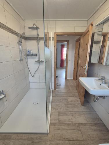 a bathroom with a shower and a sink at Feldblick in Krummhörn