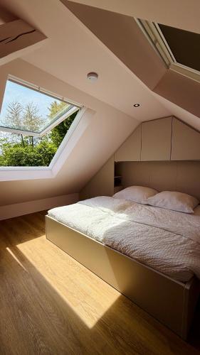 a bedroom with a bed with a large window at Chosen Hideaway Near Cologne in Neunkirchen-Seelscheid