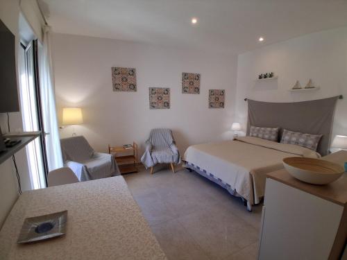 a bedroom with a bed and a chair in it at Ca' Dora in Otranto