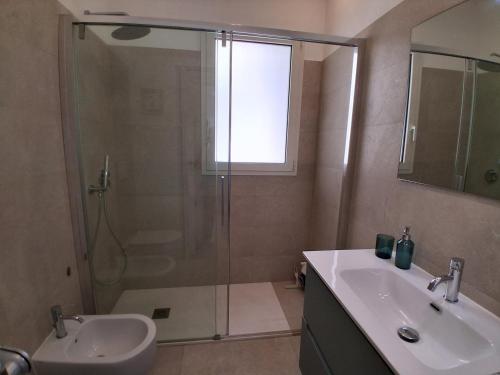 a bathroom with a shower and a sink and a toilet at Ca' Dora in Otranto