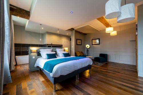 a bedroom with a large bed in a room at Maison Mathilde in Valenciennes