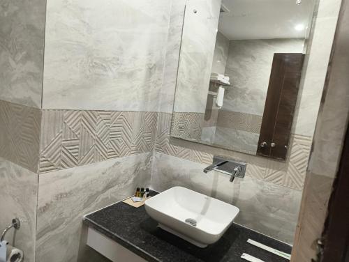 a bathroom with a sink and a mirror at Hotel Harsh Vilas-Near Tajmahal Agra in Agra