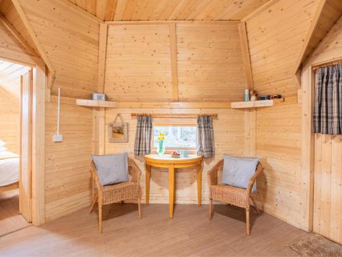 a dining room with a table and two chairs at Chalet Oak Bothy by Interhome in Coldstone