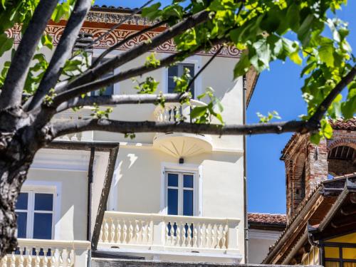 a white house with a white balcony at Apartment Bacolla by Interhome in Cocconato