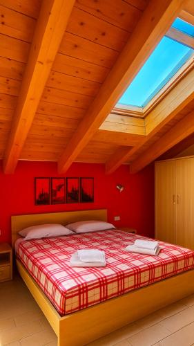 a bedroom with a large bed in a wooden ceiling at ValtellinaSuite in Villa di Tirano