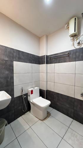 a bathroom with a toilet and a sink at Peacock residency in Edavanna
