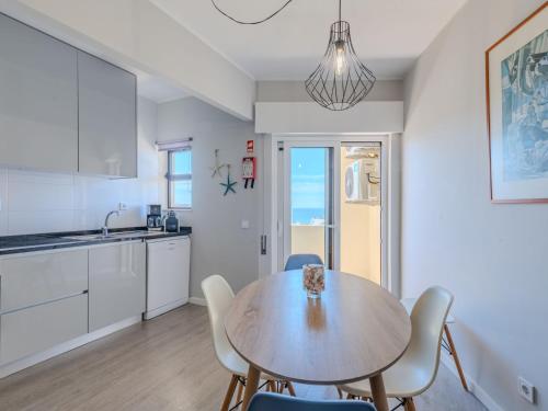 a kitchen and dining room with a table and chairs at Apartment Mirasol by Interhome in Praia da Rocha