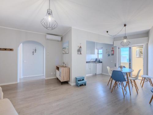 a living room and dining room with a table and chairs at Apartment Mirasol by Interhome in Praia da Rocha