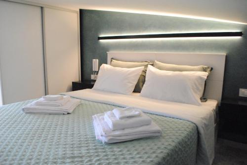 a hotel room with a bed with towels on it at Sofita Rooms in Nafplio