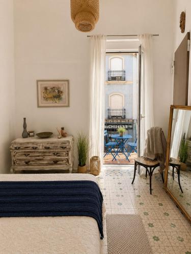 a bedroom with a bed and a view of a patio at Van Gogh Flat By La Gobernanta in Alicante