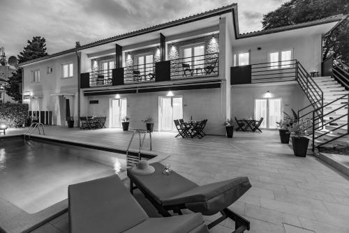 a large house with a swimming pool in front of it at CURICTA Design Apartments in Krk