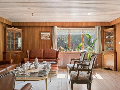 a living room with a table and chairs at Holiday Home Extorp by Interhome in Hamneda