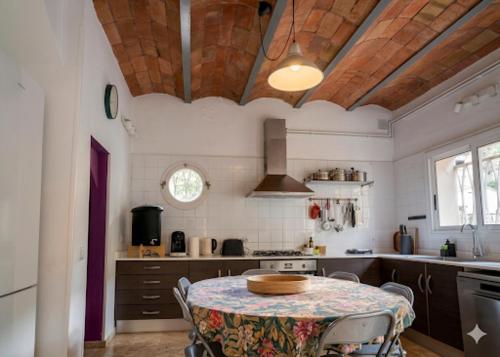 a kitchen with a table with a table cloth on it at Casa Belladona Barcelona in Barcelona