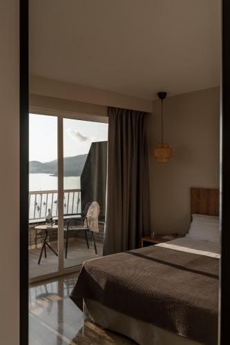 a bedroom with a bed and a view of the ocean at Caramelo Calvia Beach - Adults Only in Magaluf