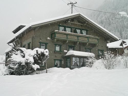 a large building covered in snow in front at Landhaus Hubert Fiegl in Sölden