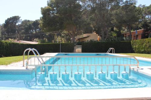 a swimming pool with water bottles in it at Breda 4a in Torroella de Montgrí