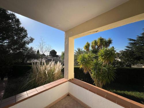 a balcony with a view of a palm tree at Casa Buckingham 27b in Torroella de Montgrí
