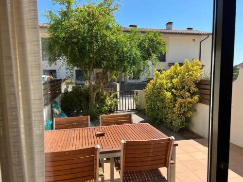a table and chairs on a balcony with a tree at Sol Ric 13 in Torroella de Montgrí
